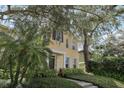 Attractive yellow two-story home featuring manicured landscaping and a welcoming facade at 316 5Th N Ave, Safety Harbor, FL 34695