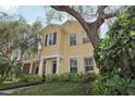 Charming two-story home with a welcoming front porch and lovely yellow siding at 316 5Th N Ave, Safety Harbor, FL 34695