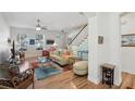 Open-concept living area with hardwood floors, stairs, and an abundance of natural light at 316 5Th N Ave, Safety Harbor, FL 34695