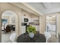 Open kitchen featuring white cabinets and modern appliances adjacent to the dining area at 3251 34Th N Ave, St Petersburg, FL 33713