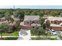 Beautiful aerial view showcases a well-maintained house, green lawns, mature trees, and neighborhood at 32718 Summerglade Dr, Wesley Chapel, FL 33545