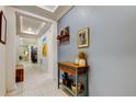 Inviting entryway with tile flooring, tray ceiling, and charming console table at 3605 W Paxton Ave, Tampa, FL 33611
