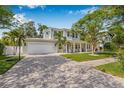 Charming two-story home with a paved driveway, basketball hoop, well-kept lawn, and inviting covered porch at 3711 W Barcelona St, Tampa, FL 33629