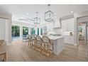 Elegant white kitchen with a large center island, pendant lighting, and barstool seating at 3711 W Barcelona St, Tampa, FL 33629