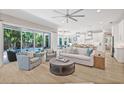 Bright, open-concept living room with hardwood floors, large sliding doors, and seamless flow to the kitchen at 3711 W Barcelona St, Tampa, FL 33629