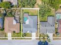 Aerial view of the property with a fenced backyard and screened-in pool at 4951 Musselshell Dr, New Port Richey, FL 34655