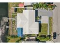 An aerial view of a home's roof, including a water view and spacious yard at 5816 Liverpool Dr, Tampa, FL 33615