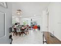 Bright, open-concept living space with modern white tile flooring and an inviting layout at 5816 Liverpool Dr, Tampa, FL 33615