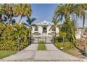 Beautiful home with a gated entry and palm tree landscaping at 721 Brightwaters Ne Blvd, St Petersburg, FL 33704