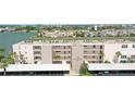 Exterior view of 'The Saratoga' condo building featuring balconies and parking spaces on a sunny day at 7645 Sun Island S Dr # 207, South Pasadena, FL 33707