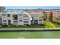 Beautiful waterfront condo with lush green lawn and tropical landscaping at 7645 Sun Island S Dr # 207, South Pasadena, FL 33707