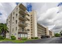 A view of the condominium building with balconies and covered parking at 8198 Terrace Garden N Dr # 109, St Petersburg, FL 33709