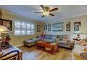 Cozy living room featuring a comfortable sectional sofa and a ceiling fan at 8198 Terrace Garden N Dr # 109, St Petersburg, FL 33709