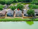 Aerial shot showcasing the home's backyard with a scenic view of a tranquil pond at 8420 Deer Chase Dr, Riverview, FL 33578