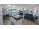 Open-concept living area with lake views, a kitchen island, and a dining table, perfect for entertaining at 9416 Star Gazer Ln, Riverview, FL 33578
