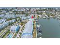 Aerial view of waterfront townhomes with boat docks and close proximity to beach at 100 Windrush Blvd # 1, Indian Rocks Beach, FL 33785