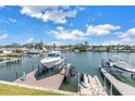 Scenic waterfront view with a private boat lift, ideal for boating enthusiasts at 100 Windrush Blvd # 1, Indian Rocks Beach, FL 33785