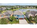 An aerial view of a beautiful home, showcasing its surroundings with a pond nearby at 10017 Smarty Jones Dr, Ruskin, FL 33573