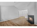 Spacious living room featuring a modern fireplace, wood-style floors and abundant natural light at 10265 Gandy N Blvd # 1406, St Petersburg, FL 33702