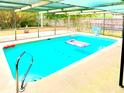 Inviting screened-in pool with clear blue water, ladder, and plenty of space for relaxing at 11272 Portsmouth St, Spring Hill, FL 34609