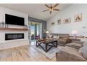 Cozy living room with a fireplace, a large TV, comfortable furniture and a sliding glass door to the porch at 11938 Bahia Valley Dr, Riverview, FL 33579