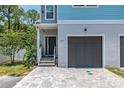 Inviting exterior features a private entry, single-car garage, and a well-maintained interlocking brick driveway at 1237 Savona Ne Dr, St Petersburg, FL 33702