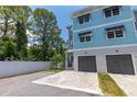 Charming townhouse exterior with a private garage, paver driveway, and easy-to-maintain landscaped grounds at 1237 Savona Ne Dr, St Petersburg, FL 33702