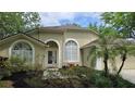Inviting front exterior showcasing a decorative window and landscaped garden at 15209 Arbor Hollow Dr, Odessa, FL 33556