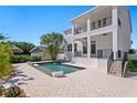 Gorgeous two-story home with a backyard featuring a luxurious pool and covered balconies at 1739 1/2 Bayou Grande Ne Blvd, St Petersburg, FL 33703