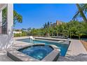 Resort style pool featuring a spa and in-pool lounge chairs, surrounded by lush landscaping at 1739 1/2 Bayou Grande Ne Blvd, St Petersburg, FL 33703