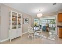 Cozy dining space with a glass table, stylish chairs, and a glass-slider view of an outdoor patio at 1809 Stancel Dr, Clearwater, FL 33764