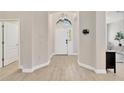 Welcoming foyer featuring tile floors, a decorative light fixture, and a view of the front door at 19246 Meadow Pine Dr, Tampa, FL 33647
