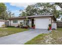 Charming home exterior featuring a driveway and an attached one-car garage at 2167 Euclid E Cir, Clearwater, FL 33764