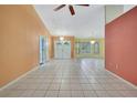 Bright foyer featuring double doors, tile flooring, and decorative lighting fixtures at 2360 Sutton Pl, Spring Hill, FL 34608