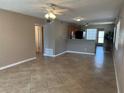 Open-concept living room featuring tile flooring and seamless transition to the breakfast bar and kitchen at 2434 Australia E Way # 22, Clearwater, FL 33763