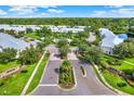 Beautiful aerial view of a community with a pool, pond, and lush landscaping at 26514 Chimney Spire Ln, Wesley Chapel, FL 33544