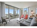 Open living room with floor-to-ceiling windows and access to a balcony at 301 1St S St # 2305, St Petersburg, FL 33701