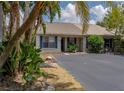 Charming exterior showcasing blue shutters and lush landscaping, offering a welcoming curb appeal at 333 Bay Pl, Safety Harbor, FL 34695