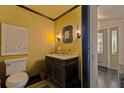 Stylish half bath featuring a decorative mirror, unique lighting, and elegant fixtures at 341 14Th Ave Ne, St Petersburg, FL 33701