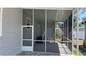 View of the home's screened in patio featuring an outside entry and access to the main home at 3722 Binnacle Dr, Tampa, FL 33611