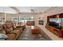 Spacious living room featuring a fireplace, comfortable seating, and plenty of natural light at 4022 Valrico Grove Dr, Valrico, FL 33594