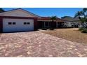 Charming single-story home with a brick driveway and attached garage at 510 64Th Ave, St Pete Beach, FL 33706