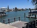 Scenic waterfront view featuring private boat docks, calm water, and neighborhood homes at 510 64Th Ave, St Pete Beach, FL 33706