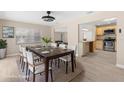 Staged dining room featuring a dark wood table and a view into the living room and kitchen at 5193 Higate Rd, Spring Hill, FL 34609