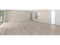 Spacious living room with new hardwood floors and sliding door for outside access at 5193 Higate Rd, Spring Hill, FL 34609