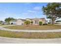 Charming single-story home featuring a manicured lawn, mature trees, and a two-car garage at 6507 61St E Dr, Palmetto, FL 34221