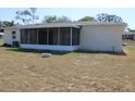 Exterior rear view of house showing a covered, screened-in patio at 7319 Holiday Dr, Spring Hill, FL 34606