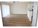 Bright living room featuring wood floors and natural light from sliding glass doors at 7319 Holiday Dr, Spring Hill, FL 34606