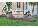 Exterior daytime shot of The Ambassador building entrance at 7400 with landscaping at 7400 Sun Island S Dr # 206, South Pasadena, FL 33707