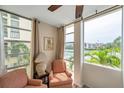 Bright seating area featuring waterfront views from oversized windows and comfortable chairs at 7400 Sun Island S Dr # 206, South Pasadena, FL 33707